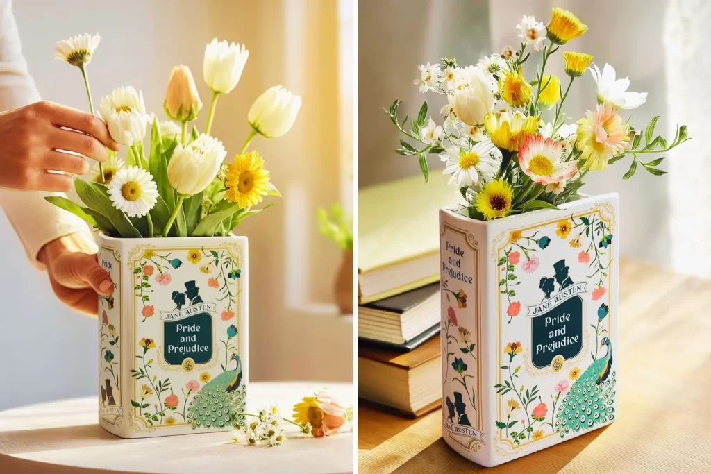 Book-shaped ceramic vase inspired by Pride and Prejudice, styled with flowers on a bookshelf.
